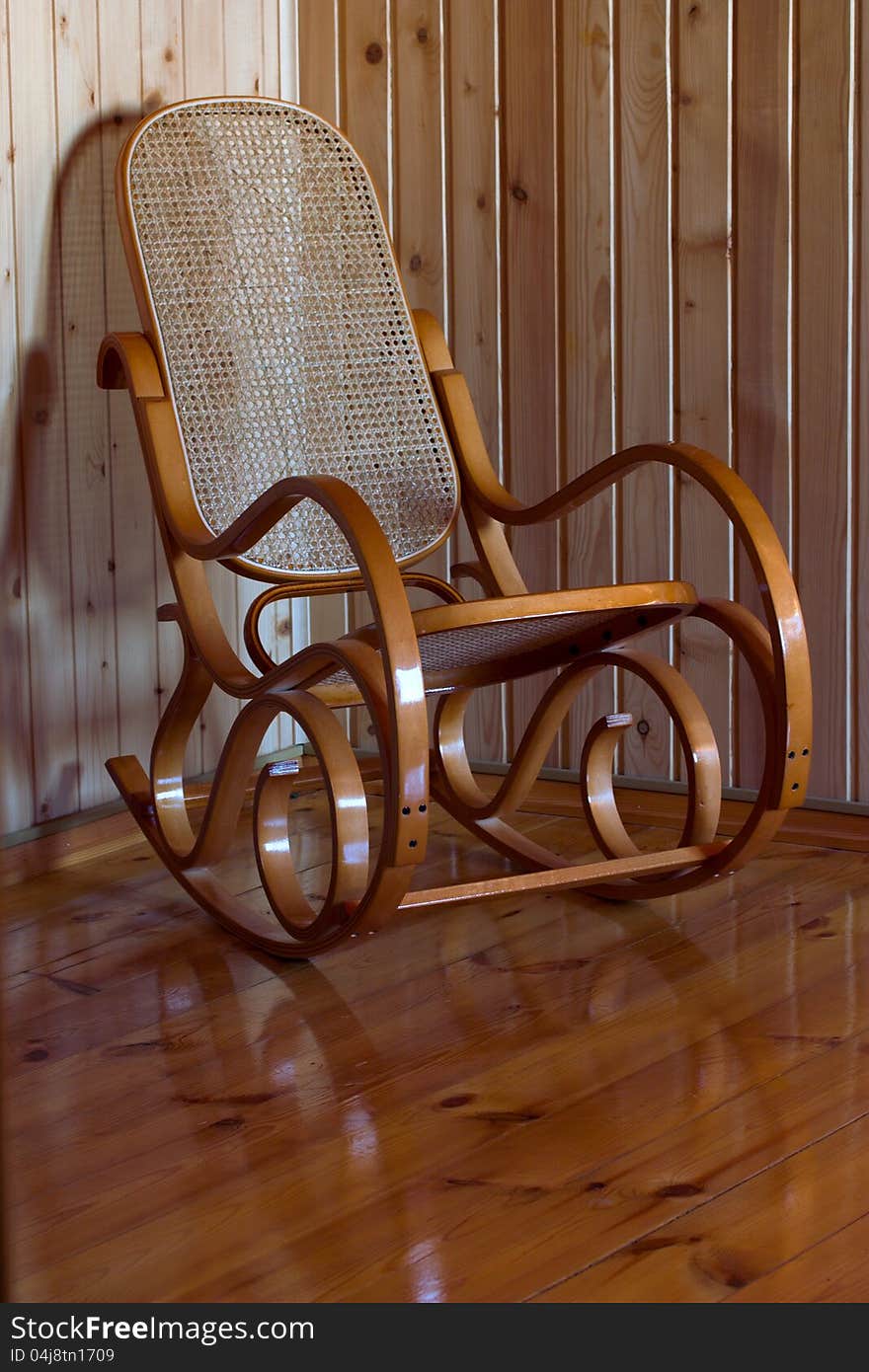 Wooden rocking chair on the wooden floor