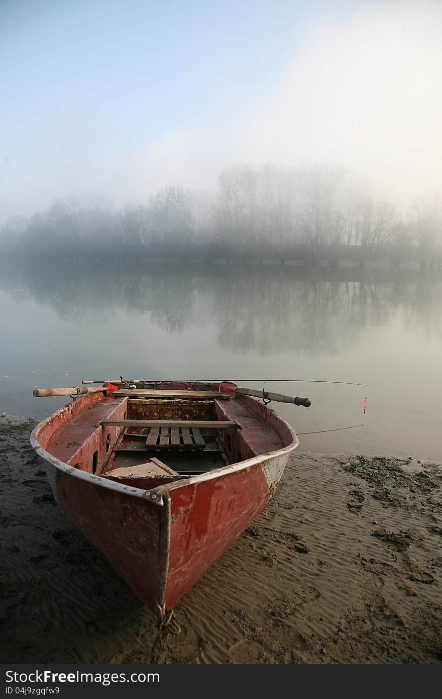 Old boat on the river bank. The river in the mist. Old boat on the river bank. The river in the mist.