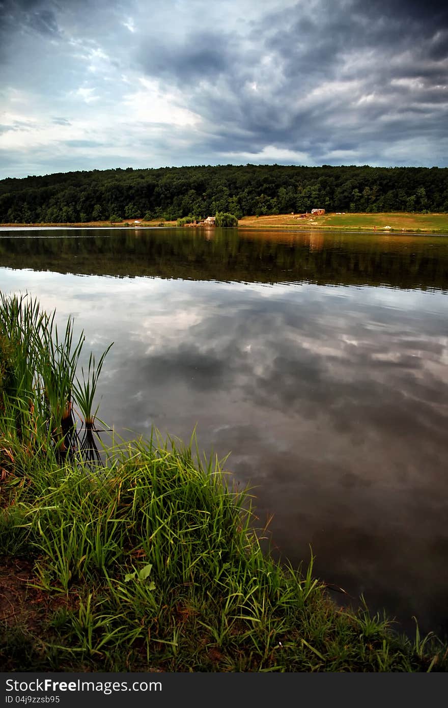 Landscape with lake and forest. Bright colors, beautiful sky. Landscape with lake and forest. Bright colors, beautiful sky.