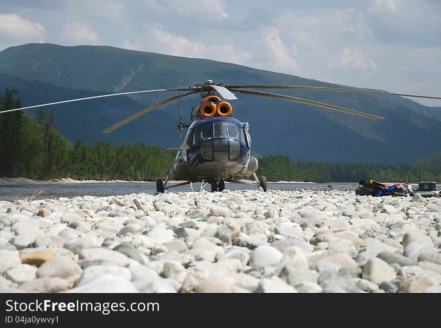 On the river bank the helicopter takes off