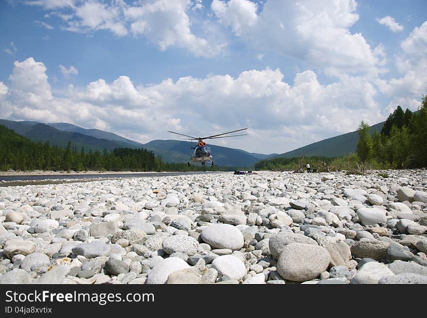 On the river bank the helicopter takes off