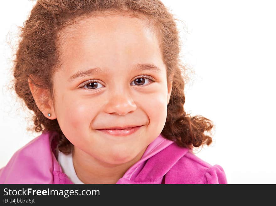 Young smiling multiracial preschooler wearing braided pigtails and pink top, whitespace background. Young smiling multiracial preschooler wearing braided pigtails and pink top, whitespace background