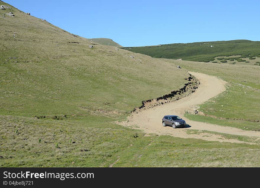 Terrain car on mountain roads. Terrain car on mountain roads