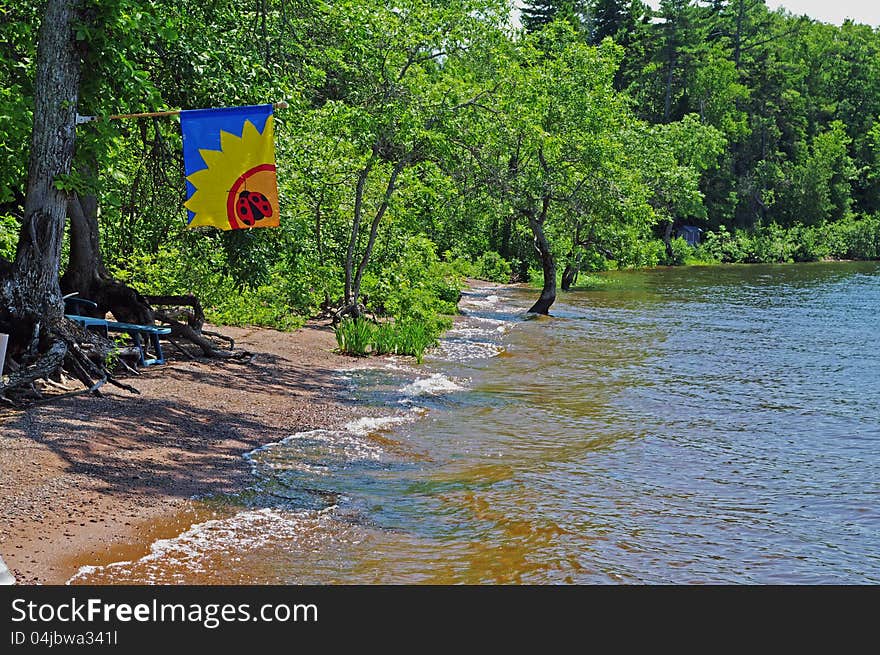 Cottage Beach with Flag to let boaters know that people are at home