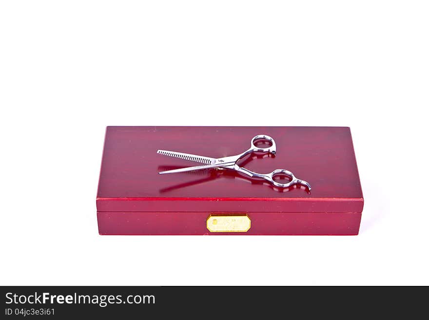 A pair of scissors on a red box