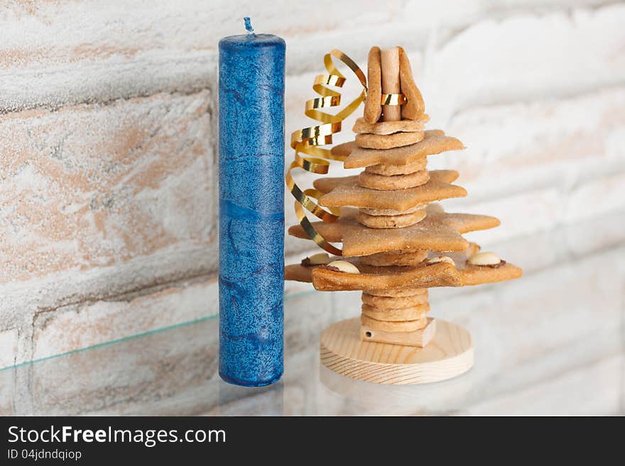 Blue candle with Christmas decorations.