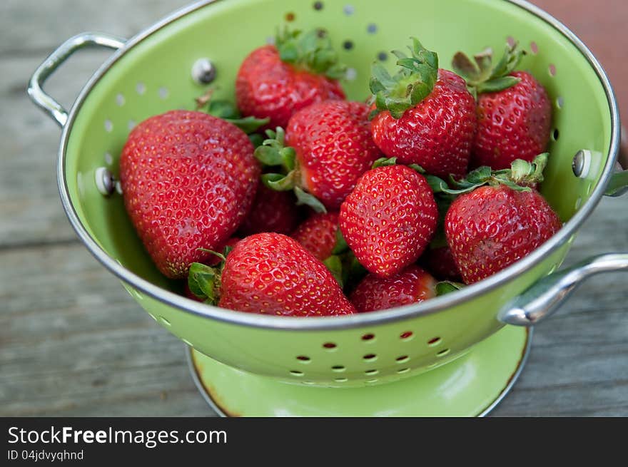 Colander full of ripe red strawberries, perfect for summer. Colander full of ripe red strawberries, perfect for summer