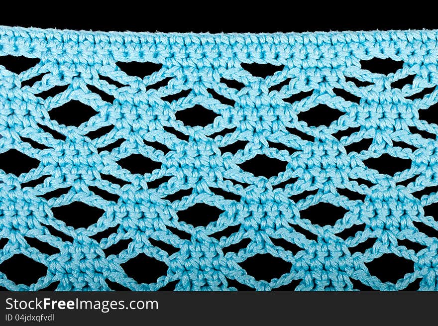 Blue knitting fabric isolated on black background