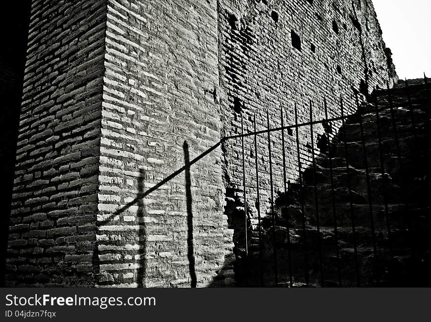 Shadow of a rail on the ancient bricks of the Colosseum.