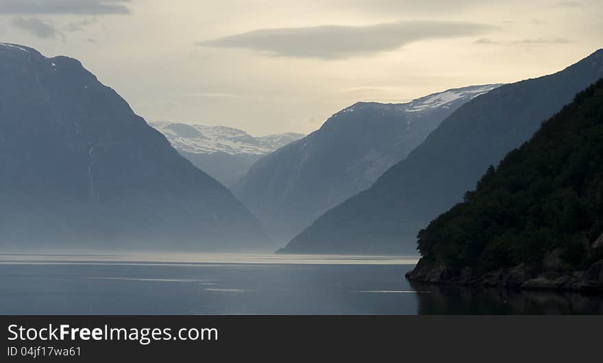 Fjords Norway sunbeam first morning light on the water. Fjords Norway sunbeam first morning light on the water