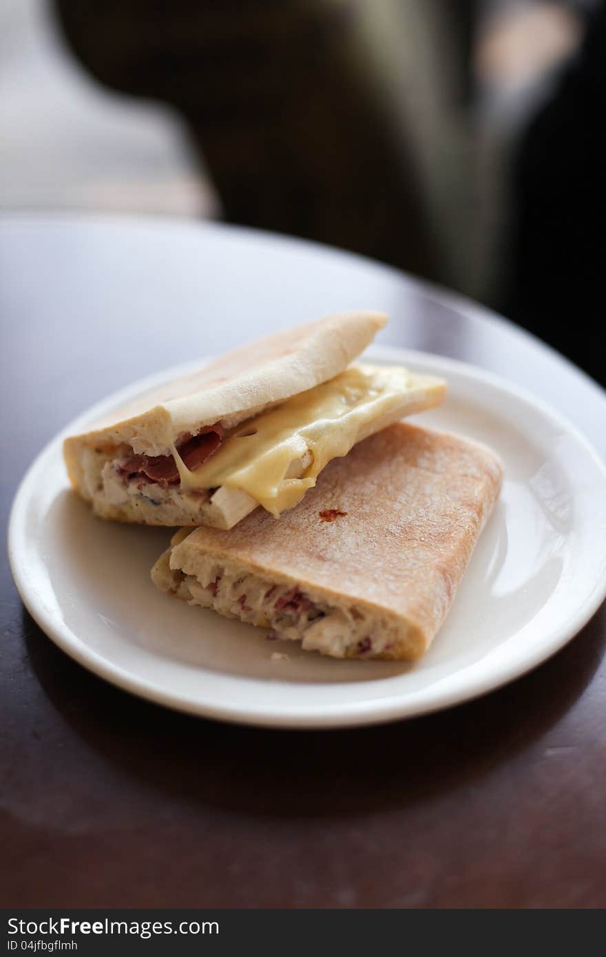 Two ham and cheese sandwiches on a plate