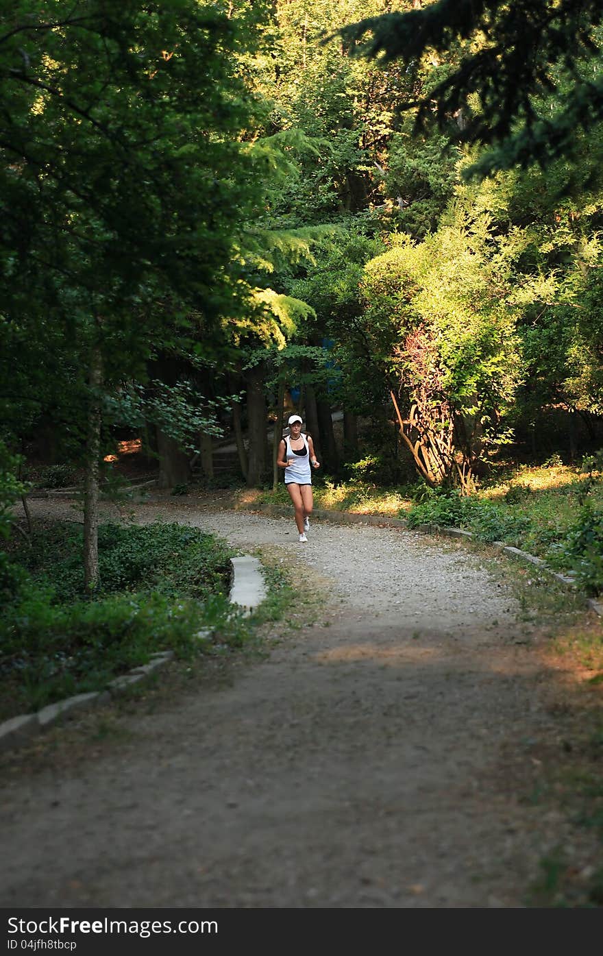 Beauty young teenage girl running across green morning park. Beauty young teenage girl running across green morning park