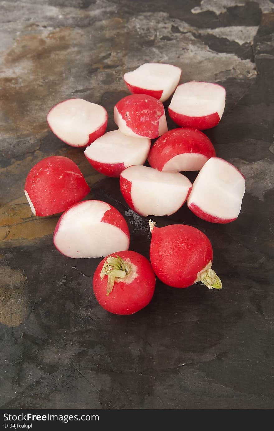 Fresh organic radish against grey slate