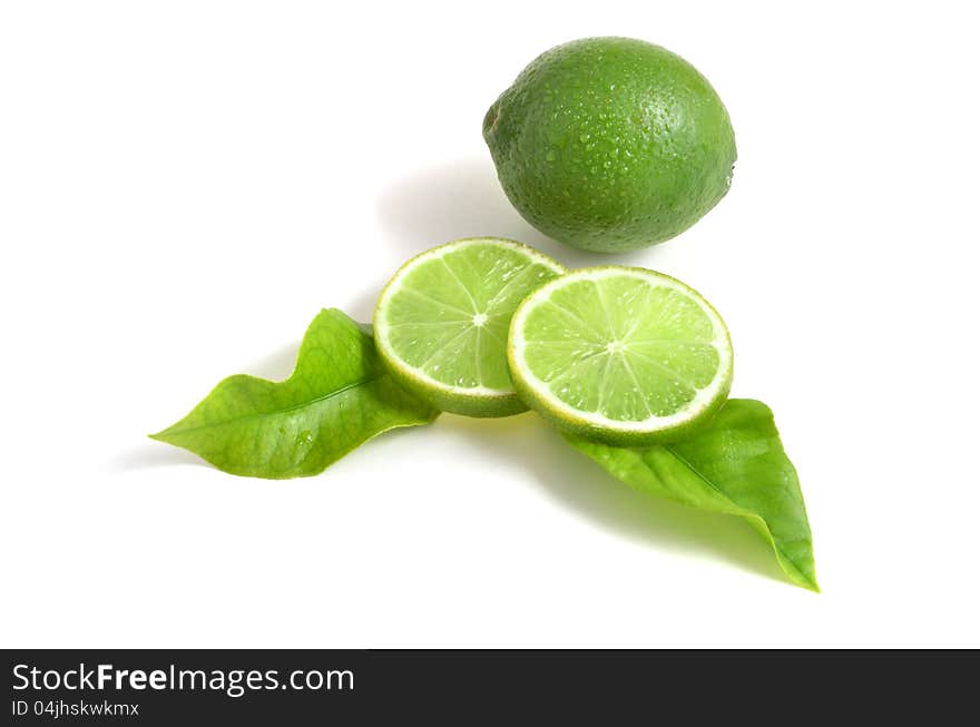 Fresh limes on white background, with leaves