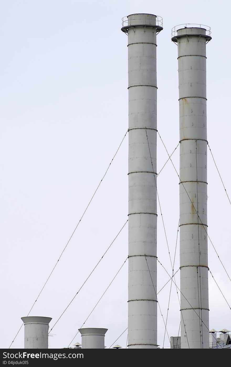 Group of old smokestacks under overcast