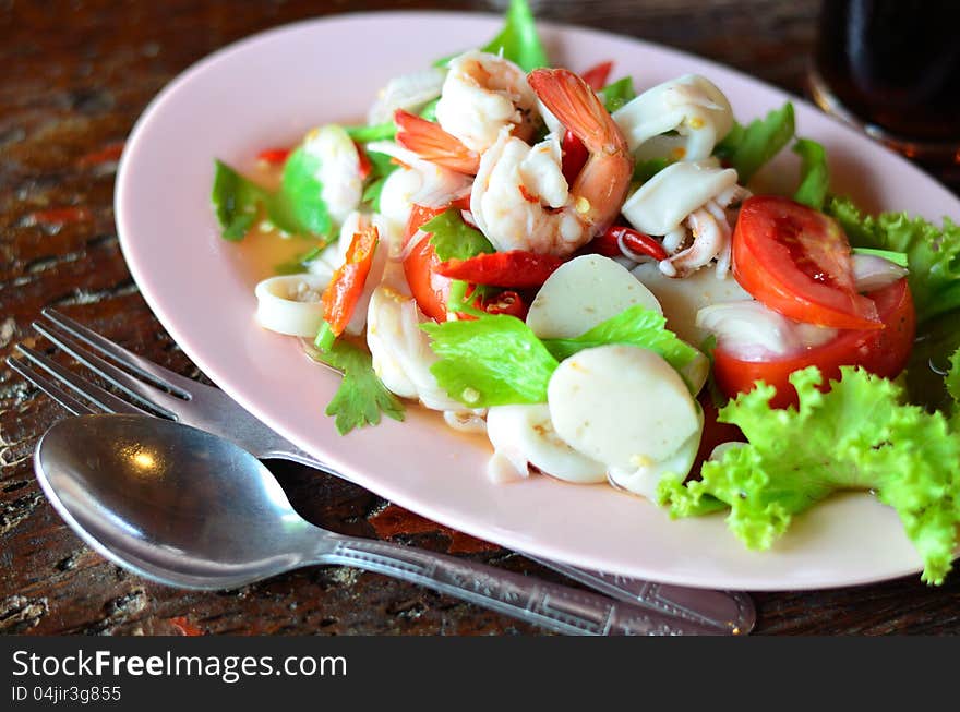 Seafood salad with wood background. Seafood salad with wood background