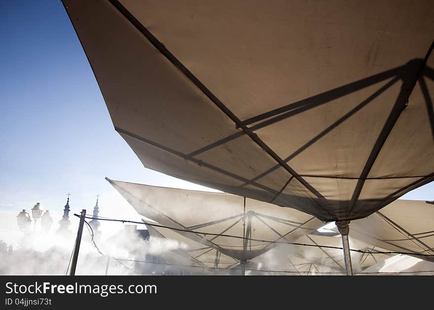 Abstract terrace umbrellas in city and blue sky