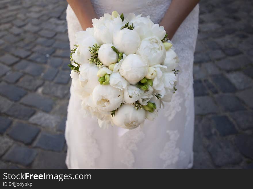 Bride holding white wedding bouquet