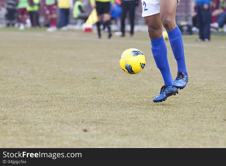 Soccer player running after the ball