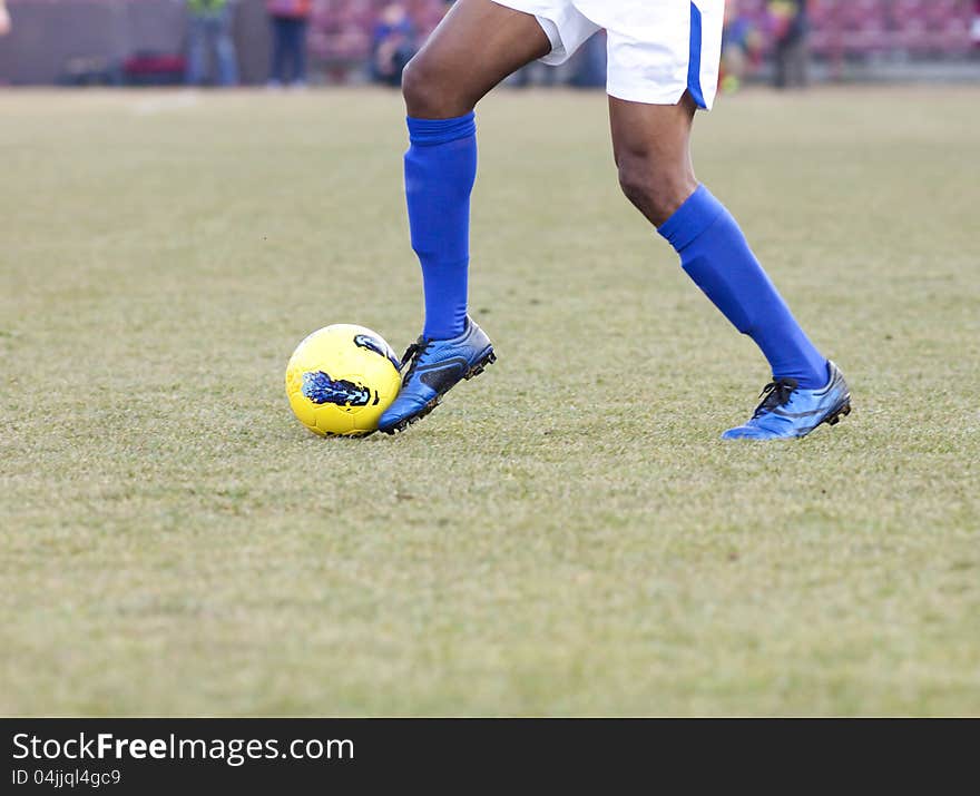 Soccer player running after the ball