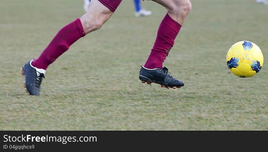 Soccer player running after the ball