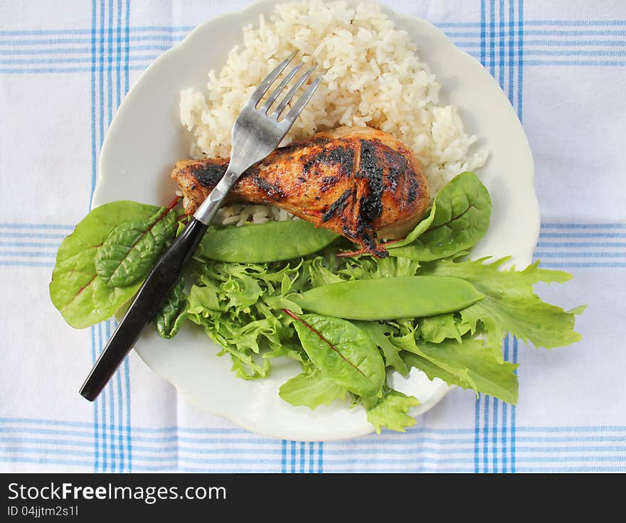 Grilled chicken leg with vegetables and rice