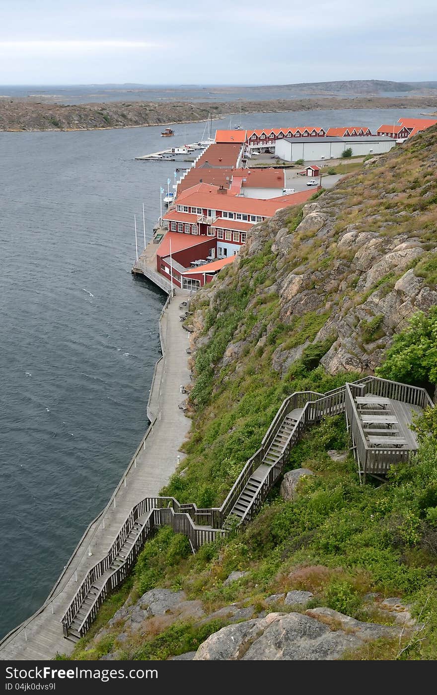 Vertical fjord landscape with generic architecture in cloudy day. Vertical fjord landscape with generic architecture in cloudy day