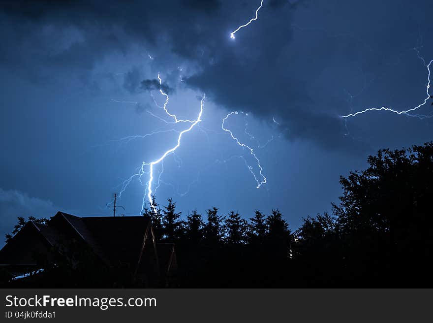 Another lightning during the night storm over a village. Another lightning during the night storm over a village