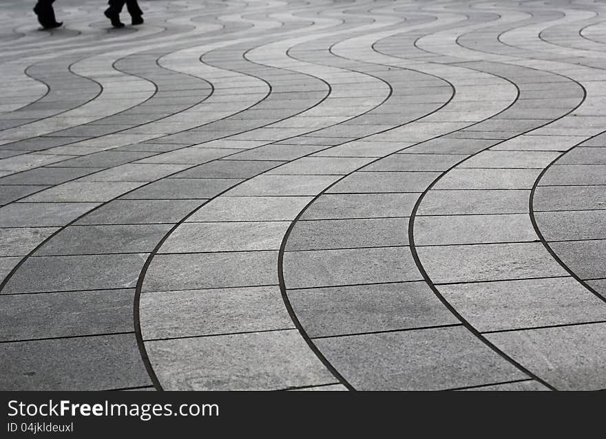 Wavy floor patten in canary wharf with people walking in the background. Wavy floor patten in canary wharf with people walking in the background