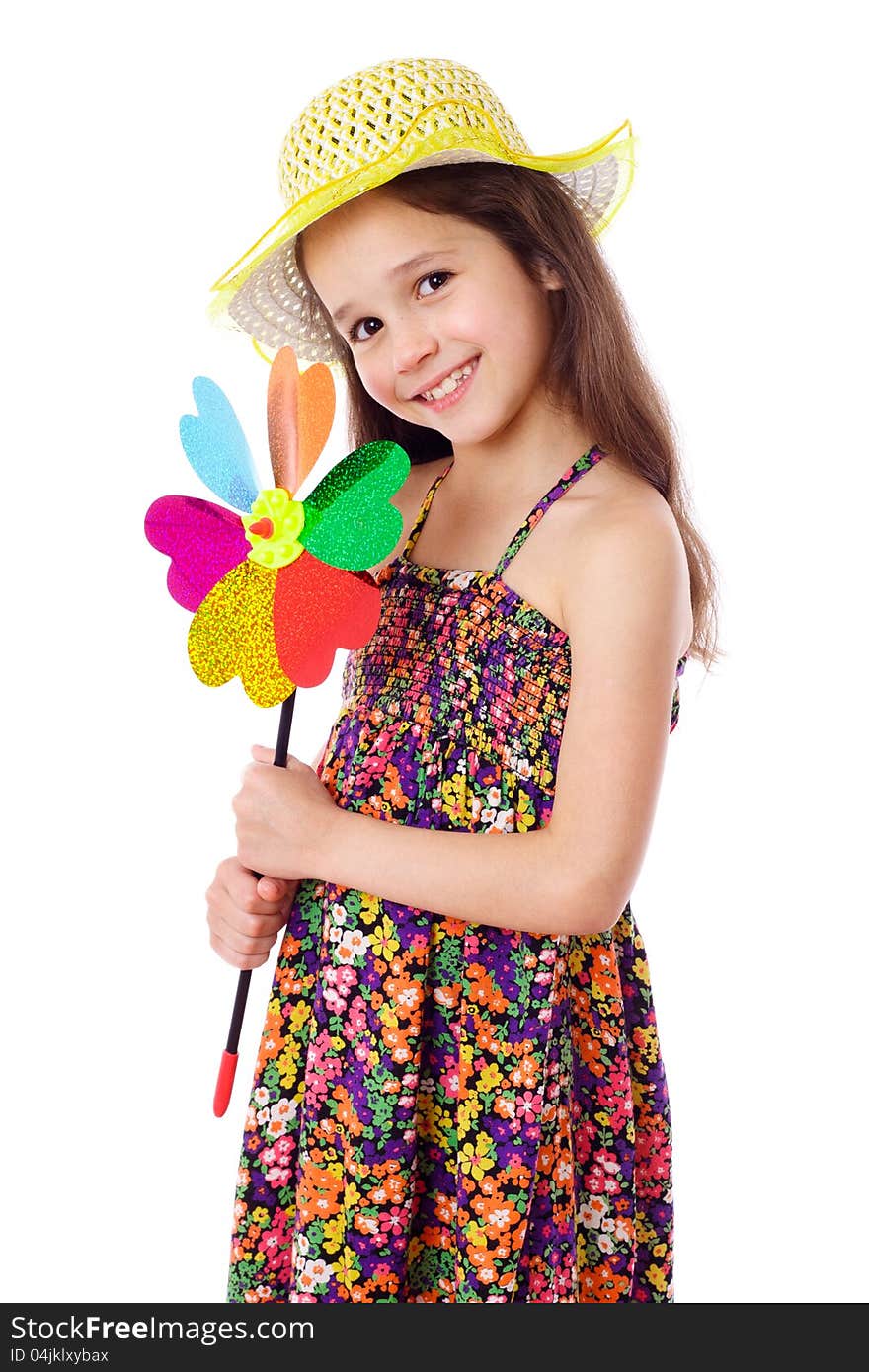 Smiling girl in yellow hat with colorful windmill, isolated on white. Smiling girl in yellow hat with colorful windmill, isolated on white