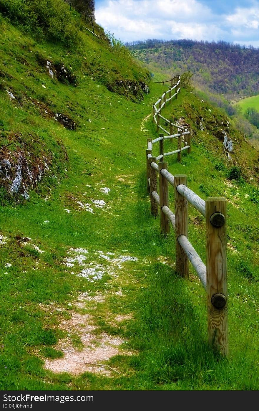 Mountain footpath protected by wooden fence. Mountain footpath protected by wooden fence