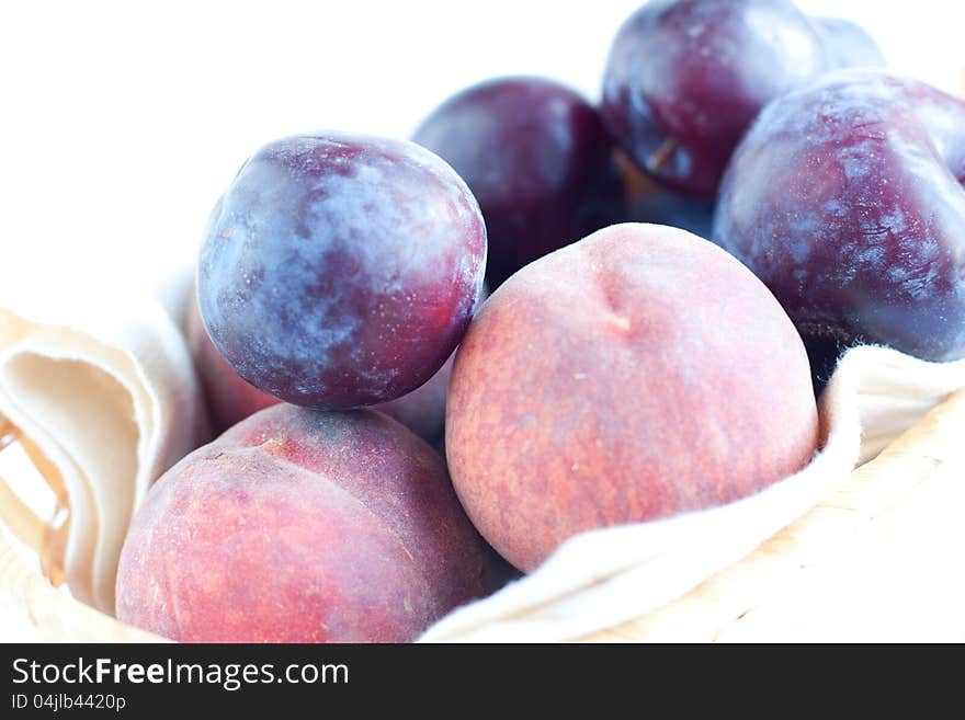 Peaches and blue plums in close-up. Peaches and blue plums in close-up