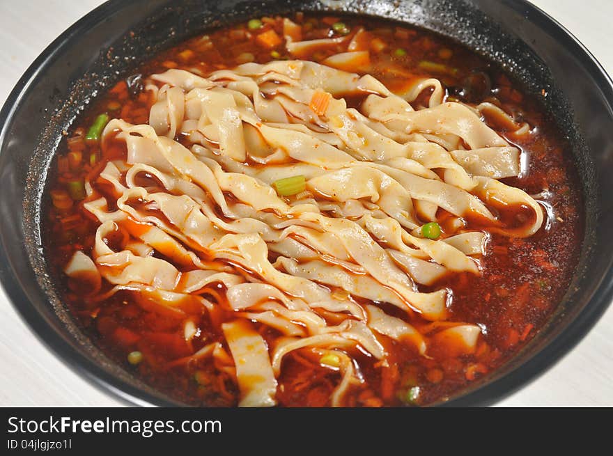 China Sichuan style noodles with pepper and minced meat. China Sichuan style noodles with pepper and minced meat