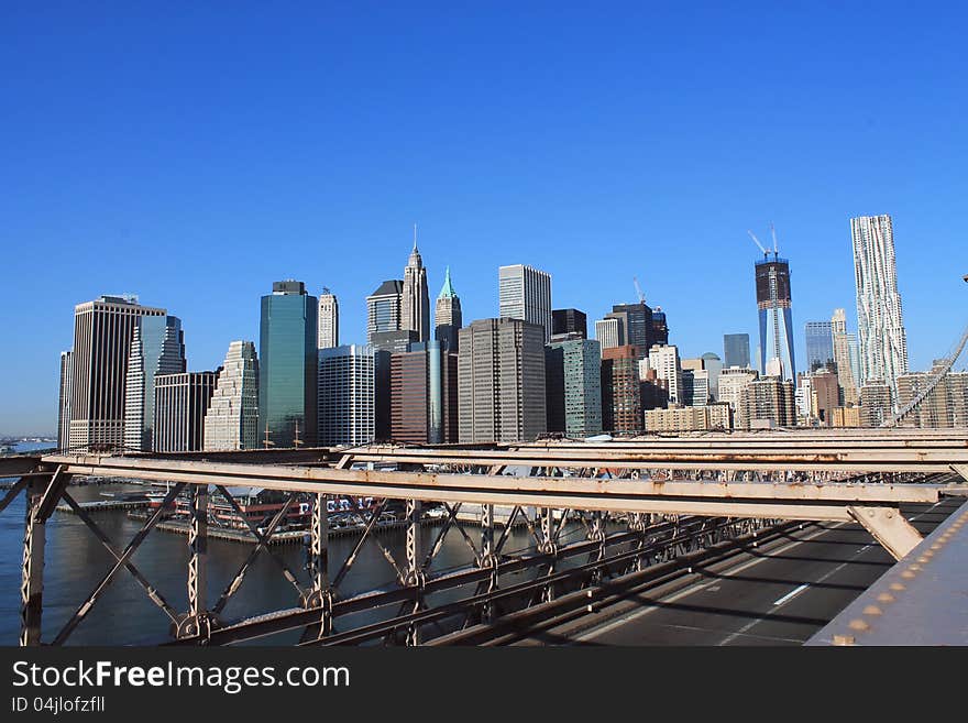 Manhattan in the background of Brooklyn Bridge in a sunny morning, New York, United States