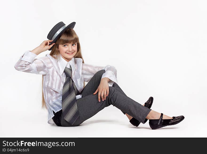 Seated girl in retro hat on a white background