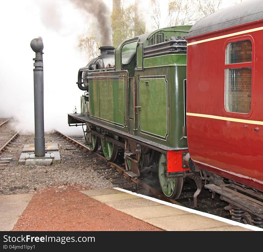 A Vintage Steam Train Pulling Away From The Station. A Vintage Steam Train Pulling Away From The Station.