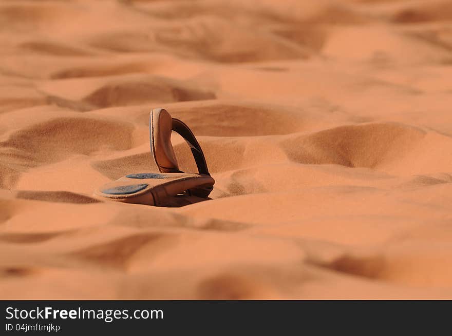 Leather sandals abandoned on beach