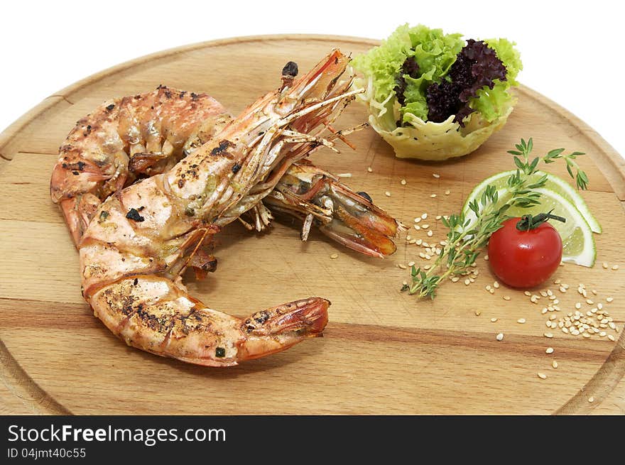 Grilled Shrimp with Orange on a wooden plate