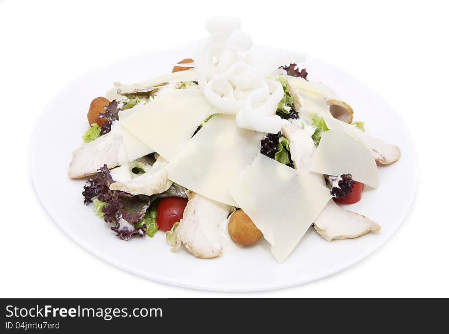 Salad with vegetables, meat and cheese on white background