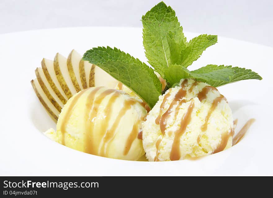 Balls of ice cream decorated with mint on a white background in the restaurant