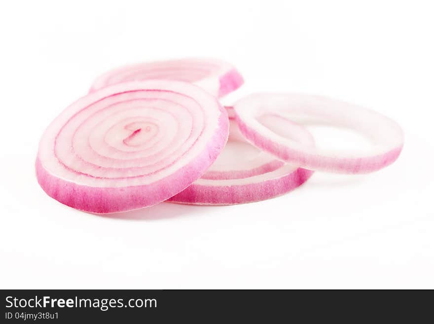 closeup of red onion slice rings isolated over white