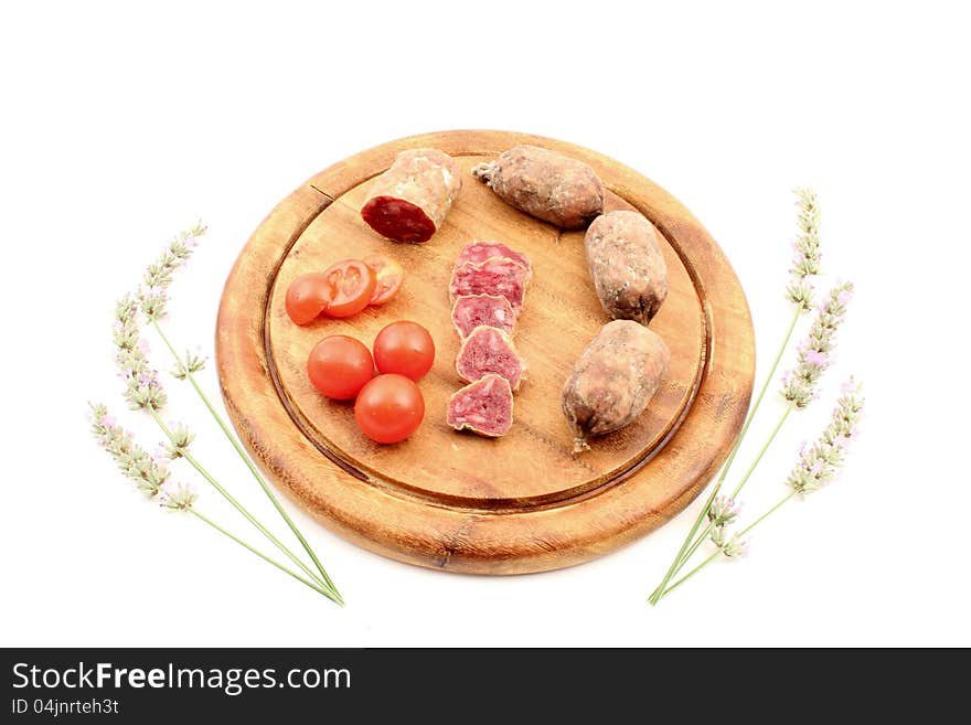 Meats with tomatoes over cutting board and lavender. Meats with tomatoes over cutting board and lavender.