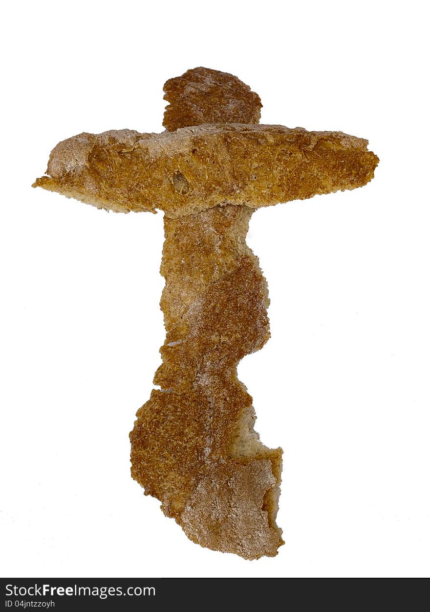 Cross made out of bread pieces isolated on white background. Cross made out of bread pieces isolated on white background.