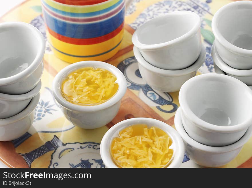 A group of thai jelly dessert with emypy cups on plate