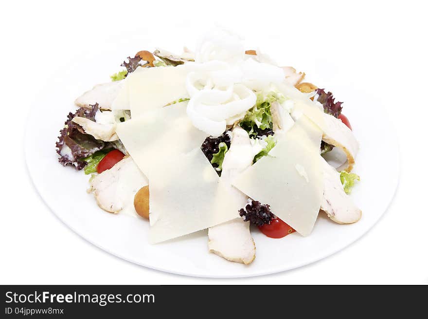 Caesar salad on a white plate in a restaurant