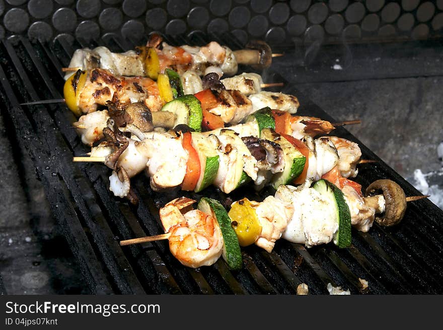 Cooking skewers of seafood in a restaurant