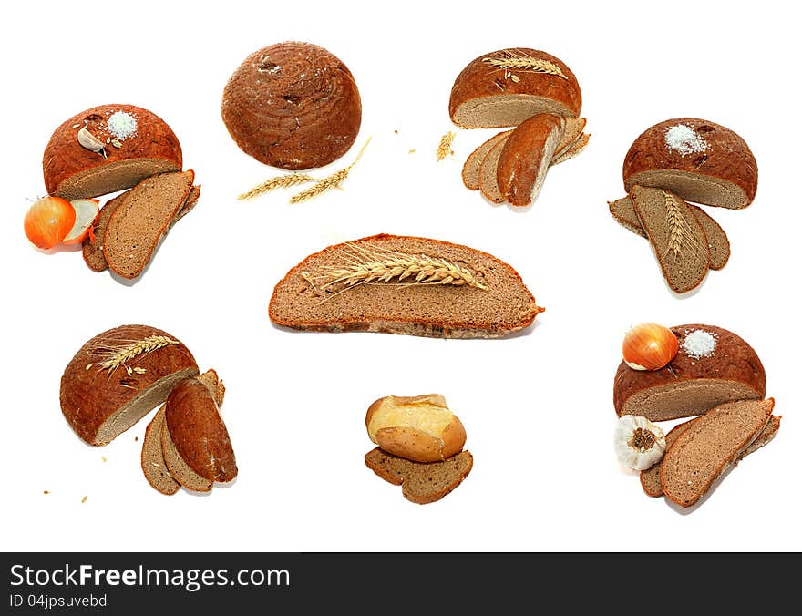 Bread, wheat ears, onions, garlic and salt isolated on the white background