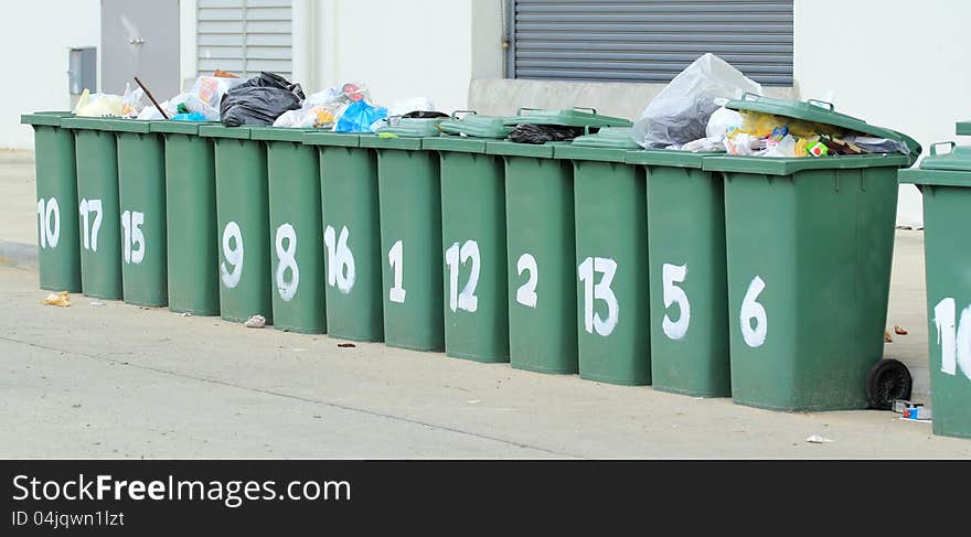 Row of large green bins, Garbage collection in the community