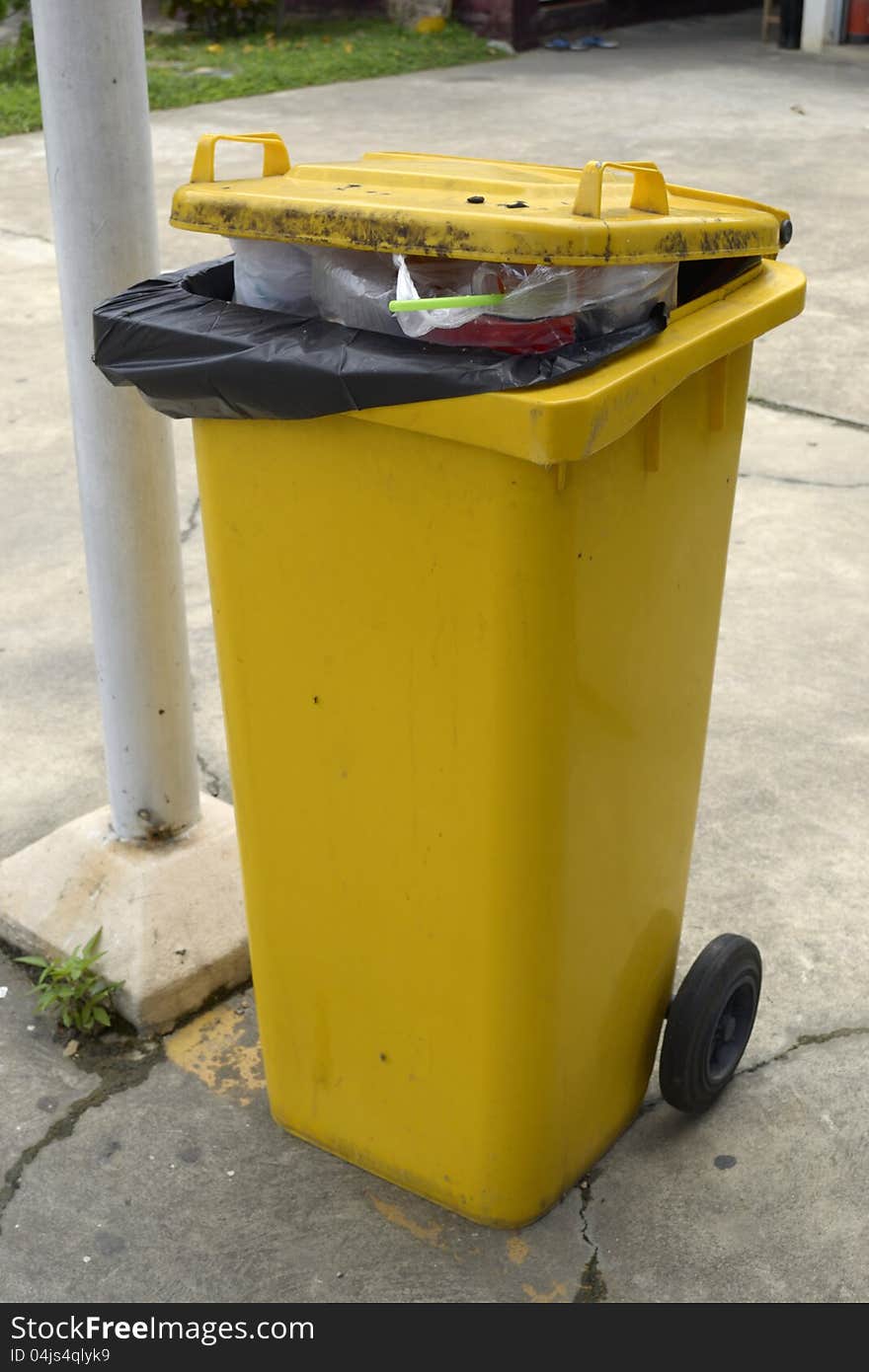 Close up of yellow full trash can