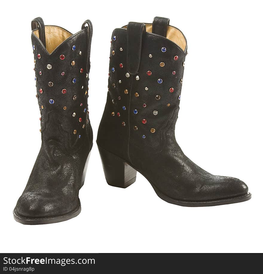 Black aged leather cowgirl boots pair with gems, isolated on white background. Black aged leather cowgirl boots pair with gems, isolated on white background.